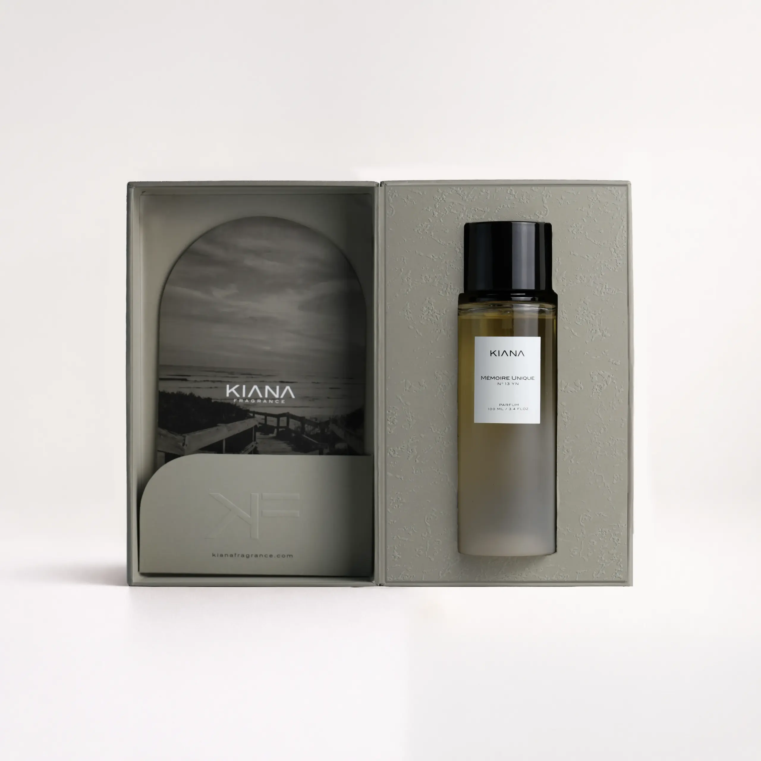 Kiana Mémoire Unique N°13 perfume in grey hard textured box with ocean landscape insert and frosted bottle